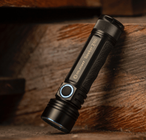 black flashlight with wooden background