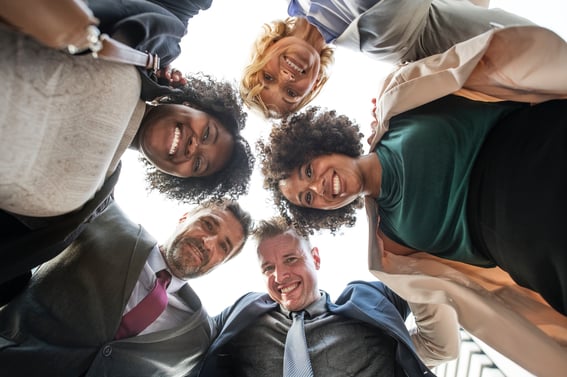 five workers staring down in a circle