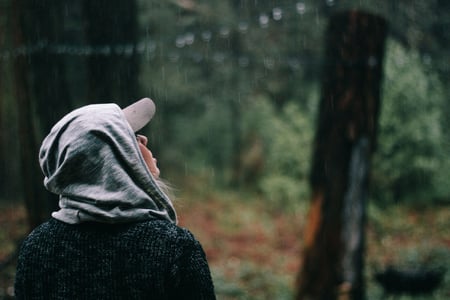 girl with hoodie stuck in the rain