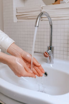 Washing hands by sink